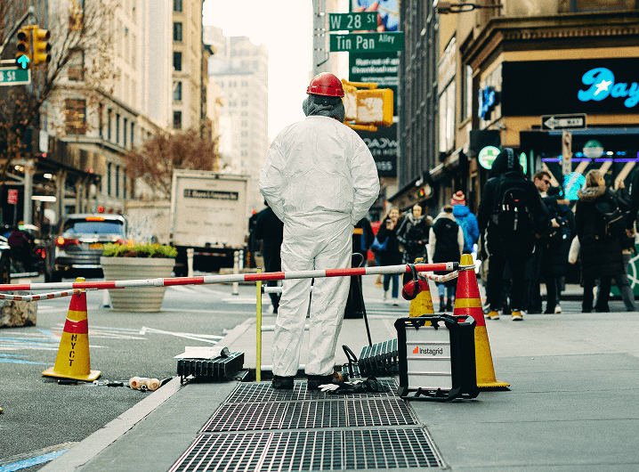 Worker standing on the sidewalk next to an Instagrid unit